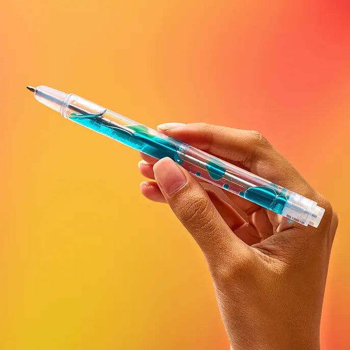 Hand holding clear scented pen with blue liquid inside against orange gradient background
