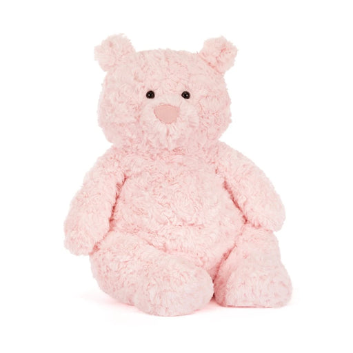 Pink fluffy teddy bear with curly textured fur sitting on white background