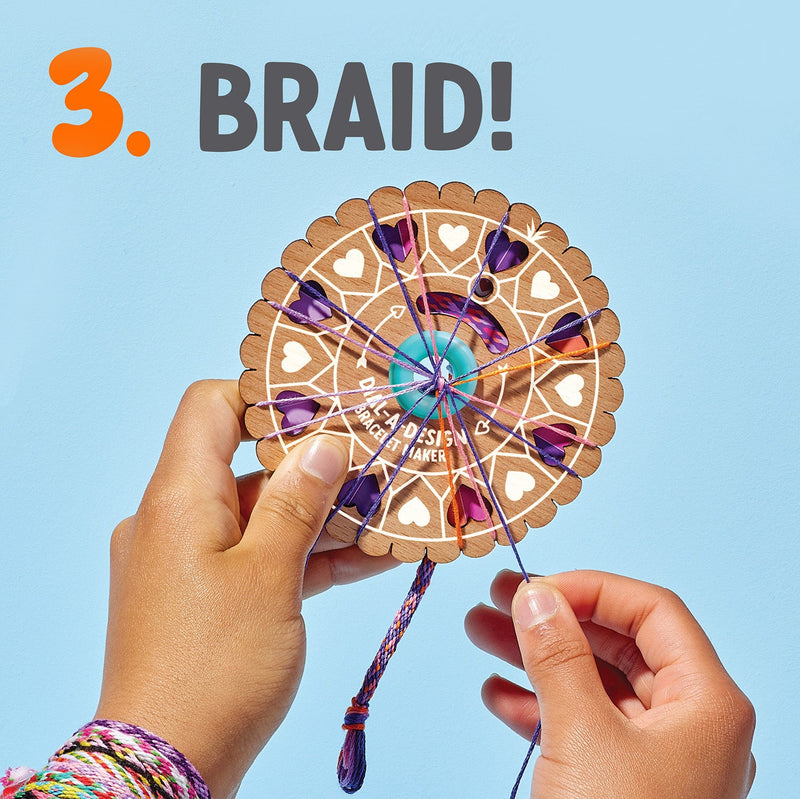 Hands using wooden circular bracelet making wheel with colorful threads for braiding
