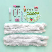 DIY craft kit components including white fur, beads, accessories for making bunny dolls