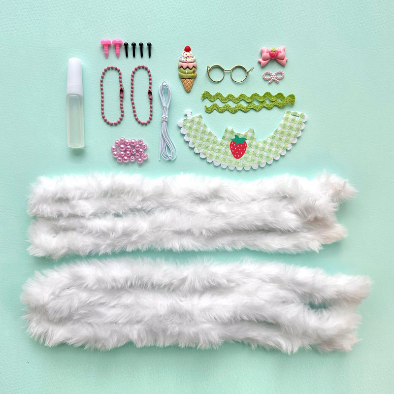 DIY craft kit components including white fur, beads, accessories for making bunny dolls