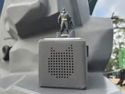 Gray Toniebox with Batman figure on top in outdoor setting