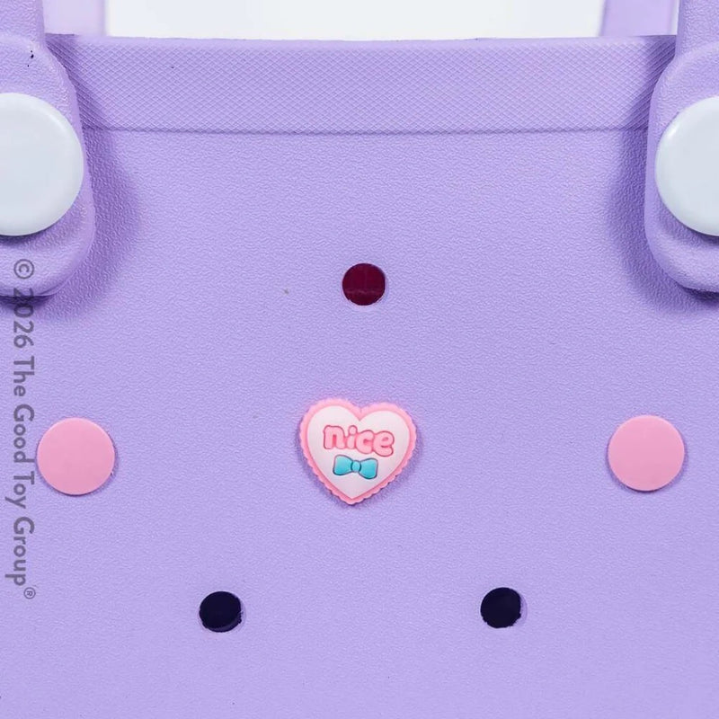 Close up of purple children's beach tote bag from Hot Focus.  Comes with heart charm and small pink purse on a white background.