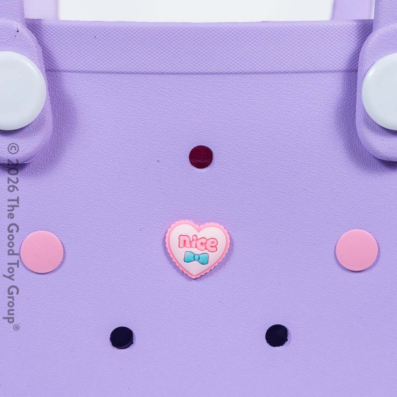 Close up of purple children's beach tote bag from Hot Focus.  Comes with heart charm and small pink purse on a white background.
