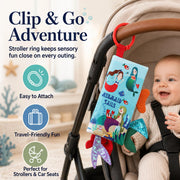 Bebe Mondo Mermaid Tails Crinkle Cloth Book attached to a stroller with its red ring.