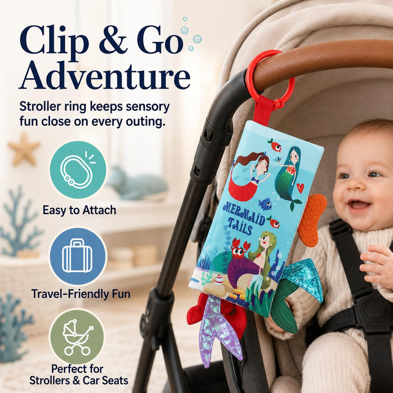 Bebe Mondo Mermaid Tails Crinkle Cloth Book attached to a stroller with its red ring.