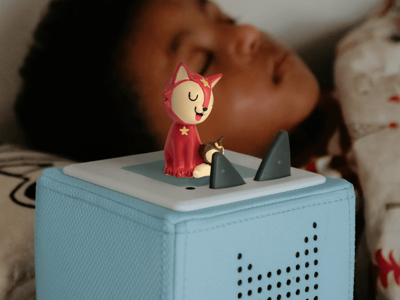 Red fox Tonie figure on Toniebox with child listening in background