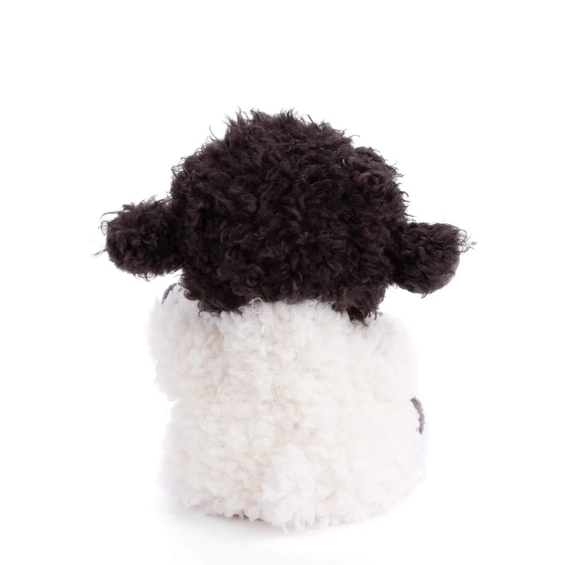 Black and white crocheted sheep plush toy on white background