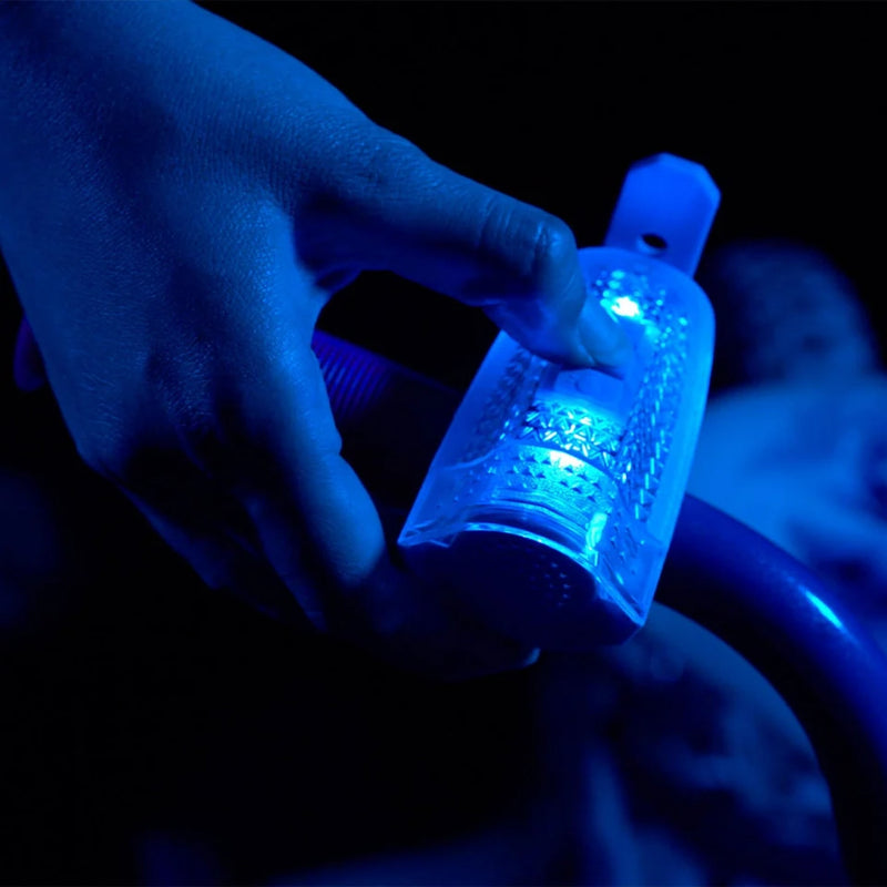Horn Brightz lights and 12 sounds toy  shown with the clear light unit and blue handle accessory on a bike. 