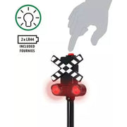 Toy railway crossing signal with red light and checkered pattern, hand pointing, and battery icon on a white background.