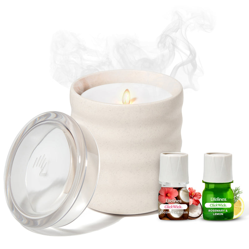 Cream colored flameless candle diffuser with lid and two essential oil bottles