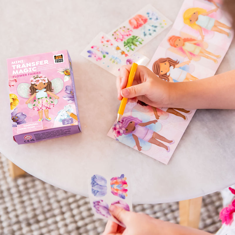 Child using Mini Transfer Magic Flower Fairies craft kit with colorful fairy illustrations