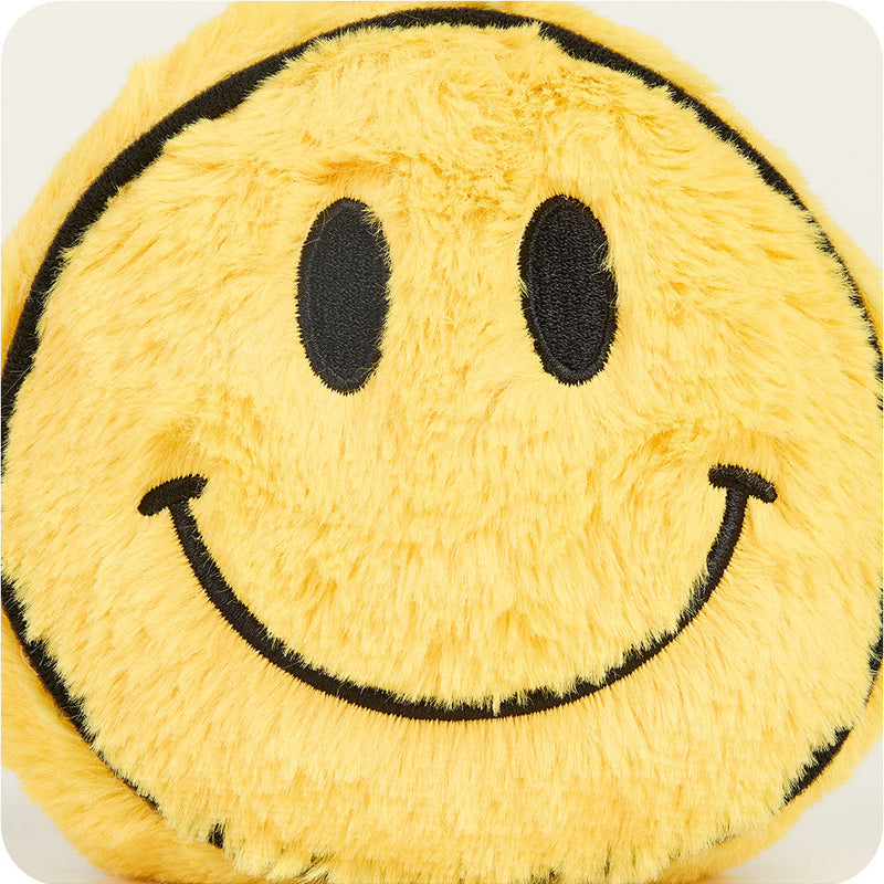 Yellow fuzzy smiley face plush toy with black embroidered features on white background
