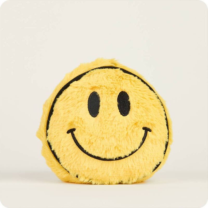Yellow fuzzy smiley face plush toy with black embroidered features on white background