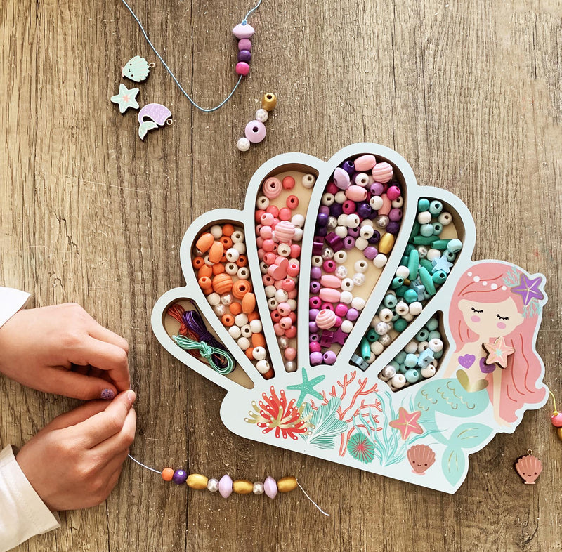 Mermaid themed wooden bead craft set with compartmentalized organizer and hands creating jewelry