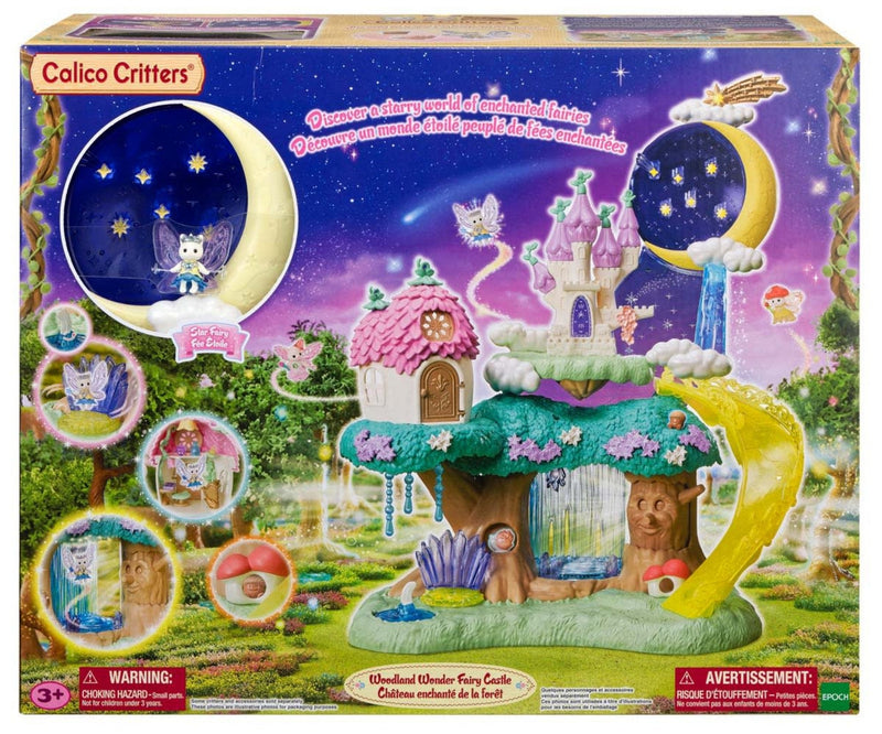 Calico Critters Magic Forest Fairy Castle toy set in its original retail packaging, featuring a colorful fairy treehouse, moon-shaped night sky, and castle on the box front.