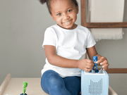 Child playing with blue PJ Masks Catboy Tonie figure and Toniebox audio player