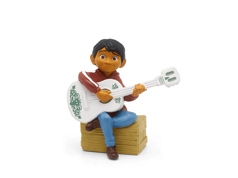 Tonie figurine of Miguel from Disney Coco with white guitar on wooden crate