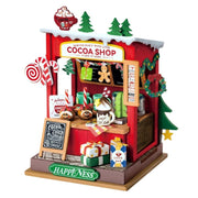 Decorative model of a cocoa shop with Christmas-themed elements on a white background