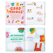 An open children's book with colorful illustrated pages showing positive phrases and drawings, photographed against a plain white background.