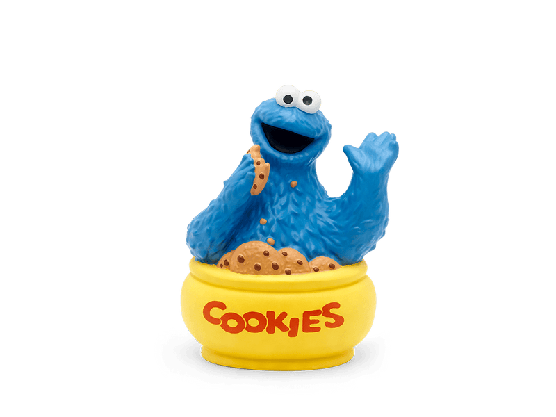 Blue Cookie Monster Tonie figurine sitting in yellow cookie jar with scattered cookie crumbs