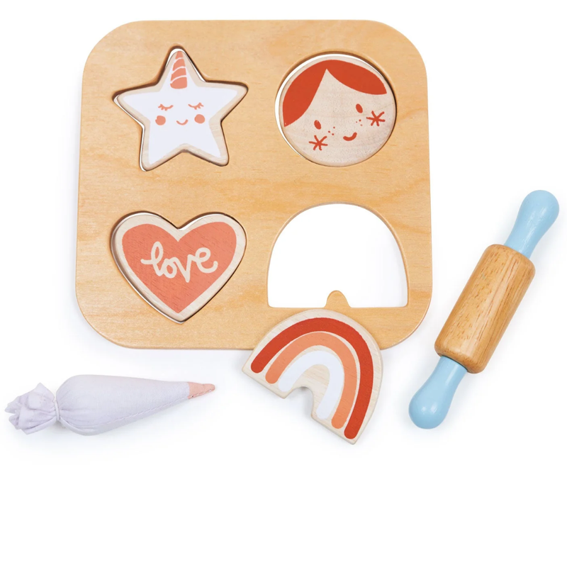 Wooden cookie baking set with shapes and a rolling pin on a white background.
