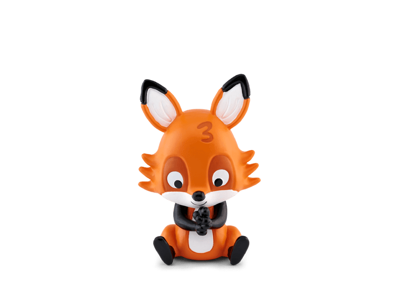 Orange fox Tonie figurine with black ears sitting against green background