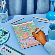 Hand working on Lifelines FlowArt dot-by-letter cozy cottage design with colorful dot pattern