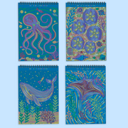 Four spiral-bound notebooks with colorful dot-pattern artwork featuring ocean themes like octopus and whale