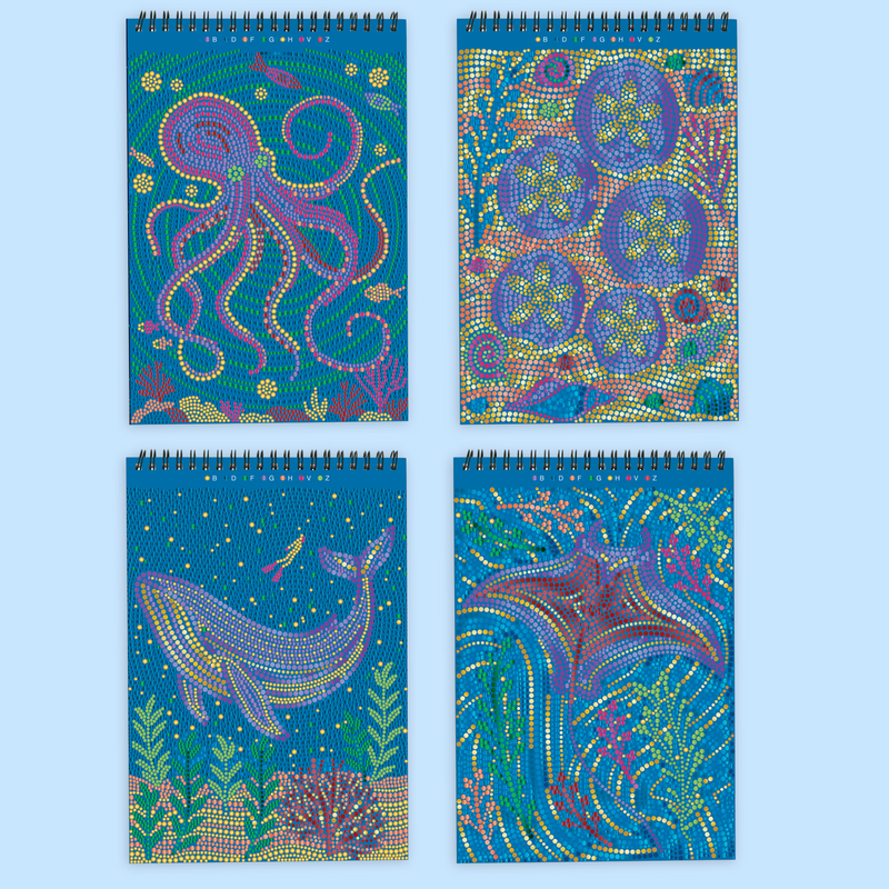 Four spiral-bound notebooks with colorful dot-pattern artwork featuring ocean themes like octopus and whale