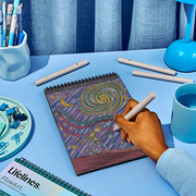 Hand drawing on FlowArt dot-by-letter spiral galaxy pattern with colorful dotted artwork