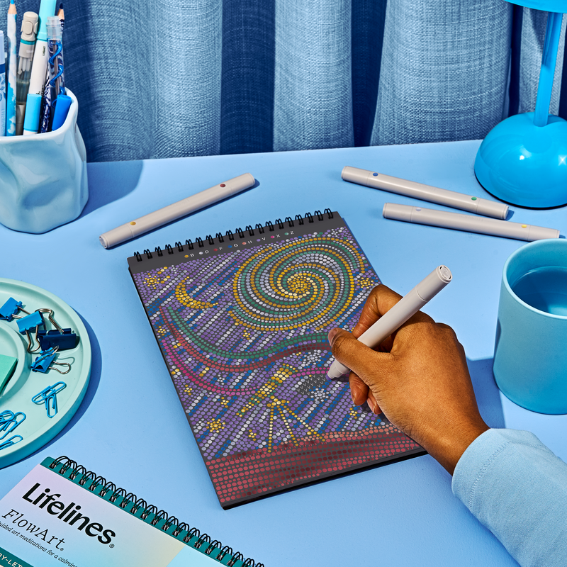 Hand drawing on FlowArt dot-by-letter spiral galaxy pattern with colorful dotted artwork