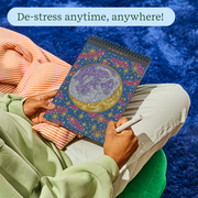Person relaxing while working on FlowArt dot-by-letter galaxy-themed art pad with colorful dotted design