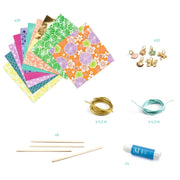 Assorted craft materials including colorful paper, gold and silver wire, wooden sticks, and a glue stick on a white background.
