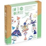 Box of 'Do It Yourself' decorative keychains with colorful designs on a white background
