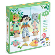 Box of children's toy figures with animals and clothing on a white background