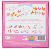 The back of a pink DJGO 'CH / Leo Perles' craft box, showing product details, included bead and bow pieces, age rating 6-10, and a barcode.