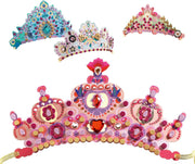 Four decorative tiara/crown accessories shown on a plain white background: a large pink royal-style crown in the foreground, a smaller blue and teal crown above left, and a smaller multicolored pink-and-gold crown above right. The crowns are embellished with faux jewels, beads, flowers, and glitter-like details.