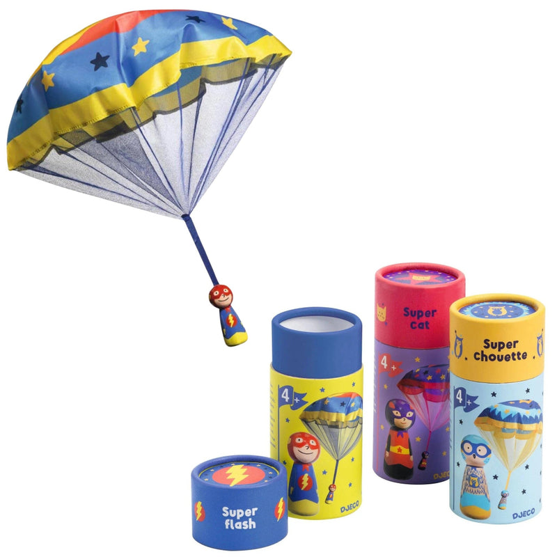 A children's toy set featuring a blue parachute with yellow stars and a small superhero figure, alongside four colorful cylindrical containers labeled Super flash, Super Cat, and Super Chouette by DUKKA.