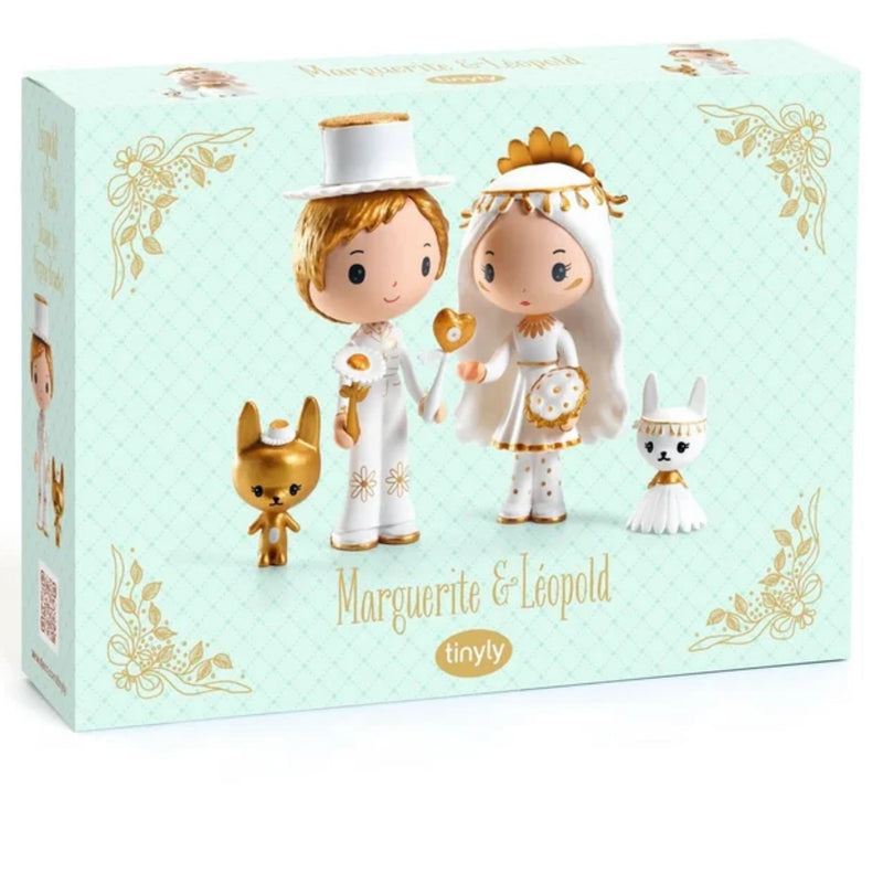 A boxed figurine set on a white background. The pale mint-green box shows the names 'Marguerite & Leopold' and the brand 'tinyly' on the front, along with printed illustrations of a bride and groom figure and two small white-and-gold animals.