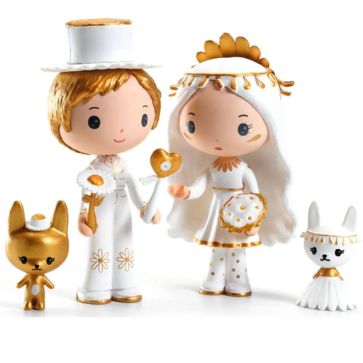 A set of four Tinyly figurines on a plain white background: a bride and groom couple in white and gold wedding attire, plus two small gold and white animal figures.