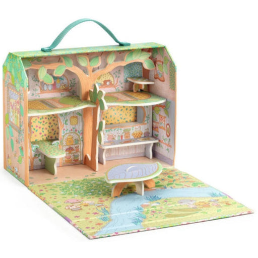 A children's playhouse set in a carry case with a carrying handle. The open case features a multi-level house with a tree motif, patterned wallpaper, a small table, and a matching illustrated play mat on a white background.