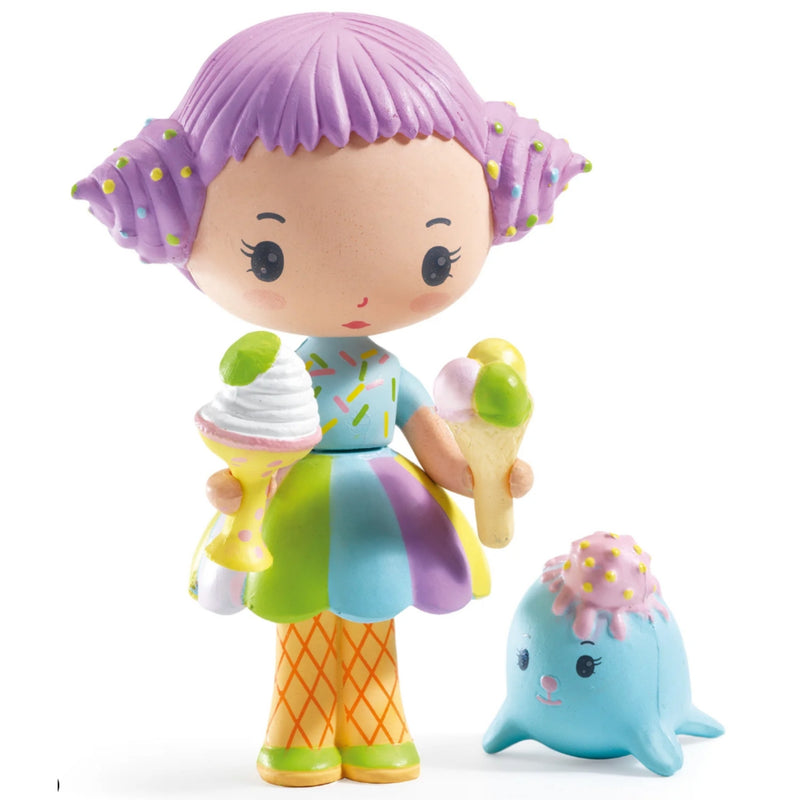 A colorful toy figurine of a cute girl with purple hair holding ice cream cones, standing next to a small blue ice cream puddle character on a white background.
