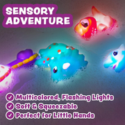 Multicolored dinosaur bath toys with lights and soft texture on a water surface.