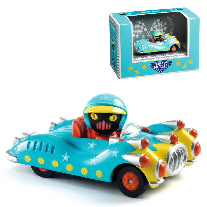 A colorful toy race car with a cartoon driver figure, shown in front of its retail box on a white background. The car is turquoise blue with yellow stars, a yellow front section, red wheels, and silver spikes.