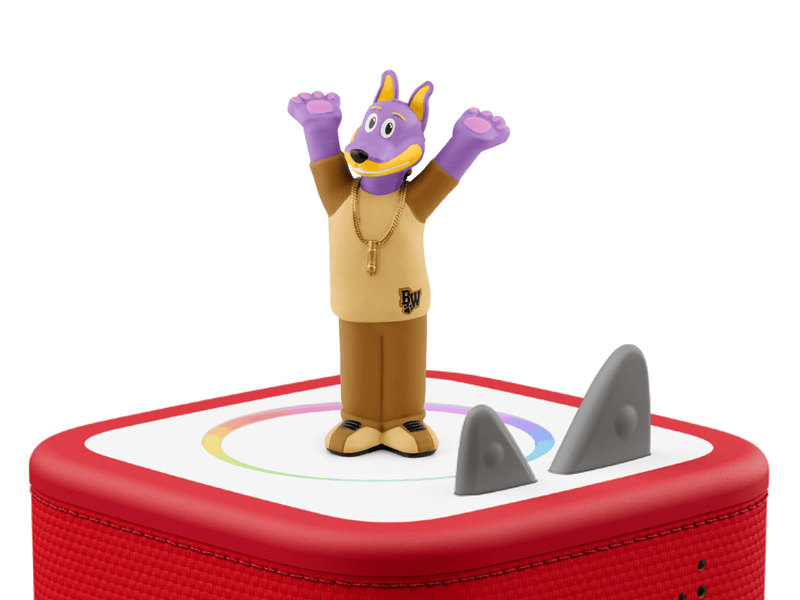 Purple dog character Tonie figure on red Toniebox audio player with shark fins