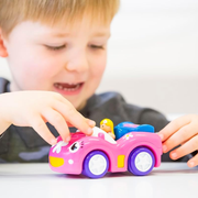 Child playing with the pink Dynamite Daisy race car from WOW! Toys.