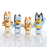 Four colorful Bluey character squirter toys arranged on reflective white background