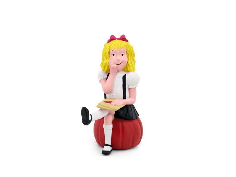 Tonie Eloise figurine with blonde hair, red bow, white blouse sitting on red apple