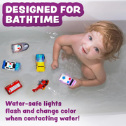 Child playing in a bathtub with colorful emergency toy cars, surrounded by water-safe lighted toys from TubWorks.